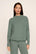 Model is wearing Cozy Time Mock Neck Pullover in Desert Sage