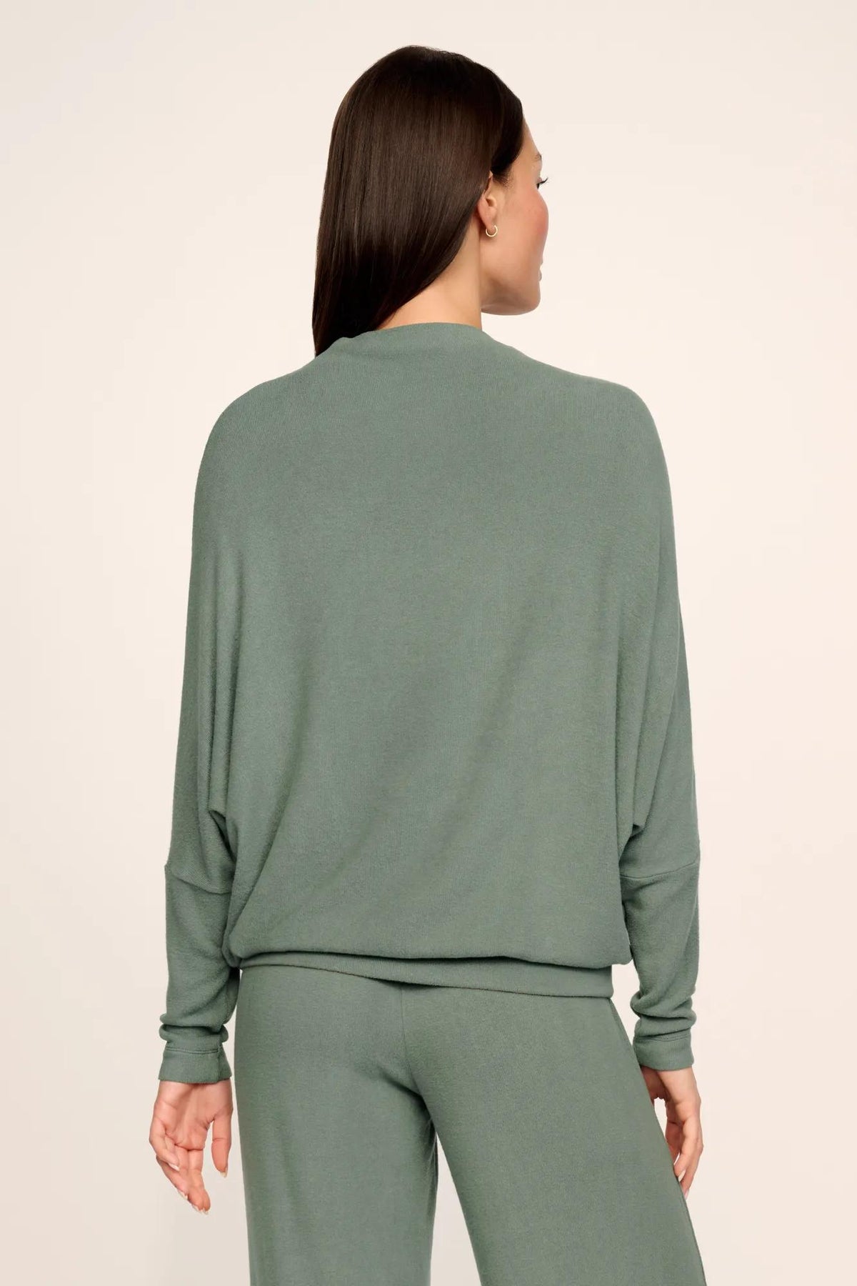 Model is wearing Cozy Time Mock Neck Pullover in Desert Sage