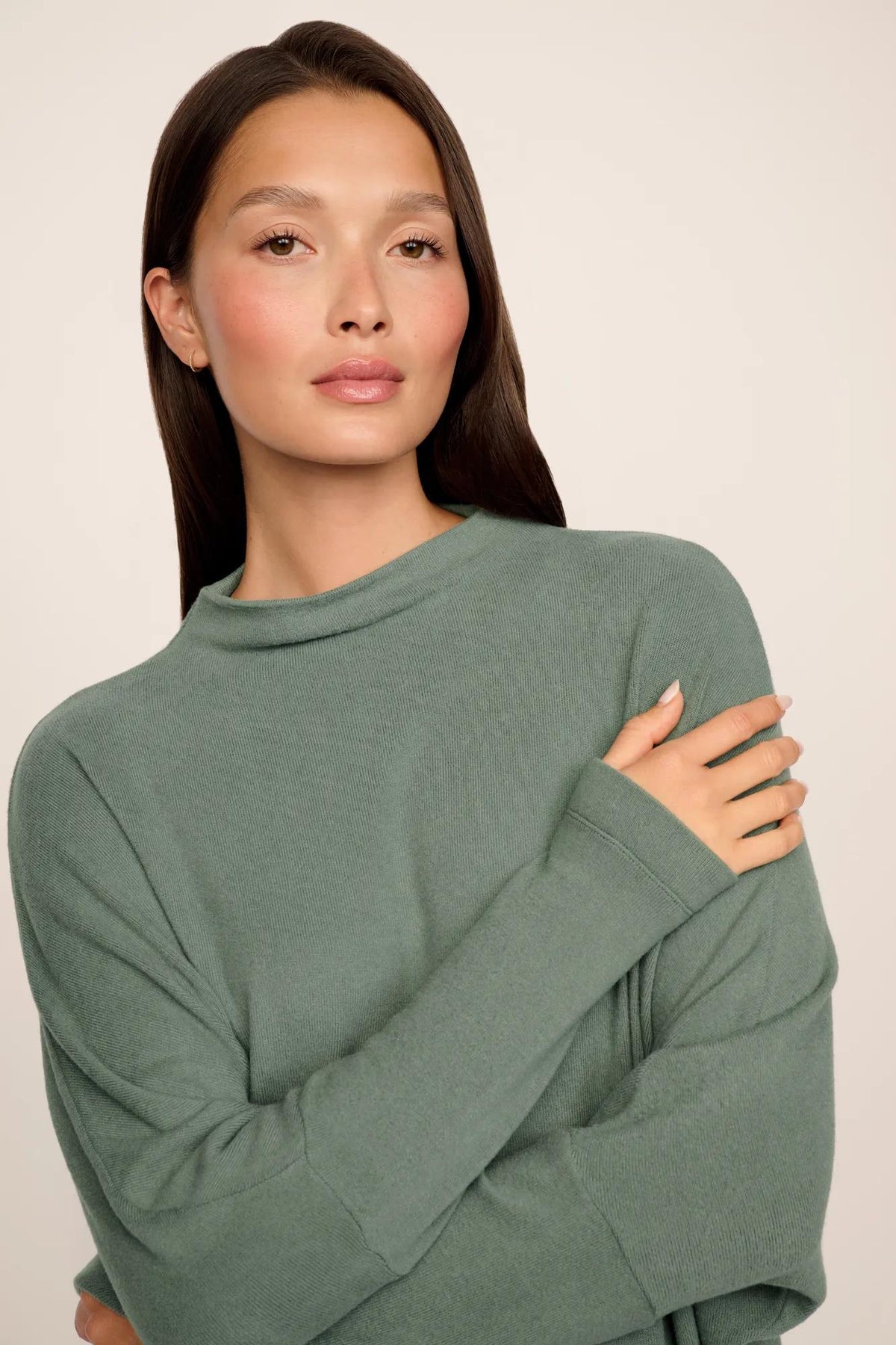 Model is wearing Cozy Time Mock Neck Pullover in Desert Sage