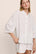 Model is wearing Linen Blend Relaxed Quarter Sleeve Top in SummerDaisyWhite/PeachDust