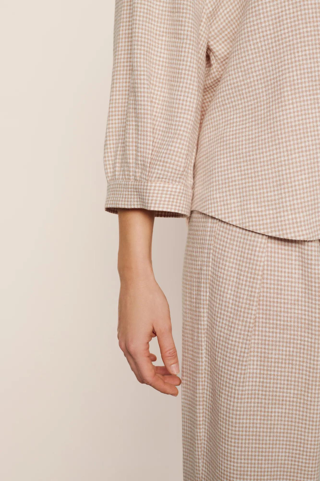 Model is wearing Linen Blend Relaxed Quarter Sleeve Top in Gingham White/Warm Taupe