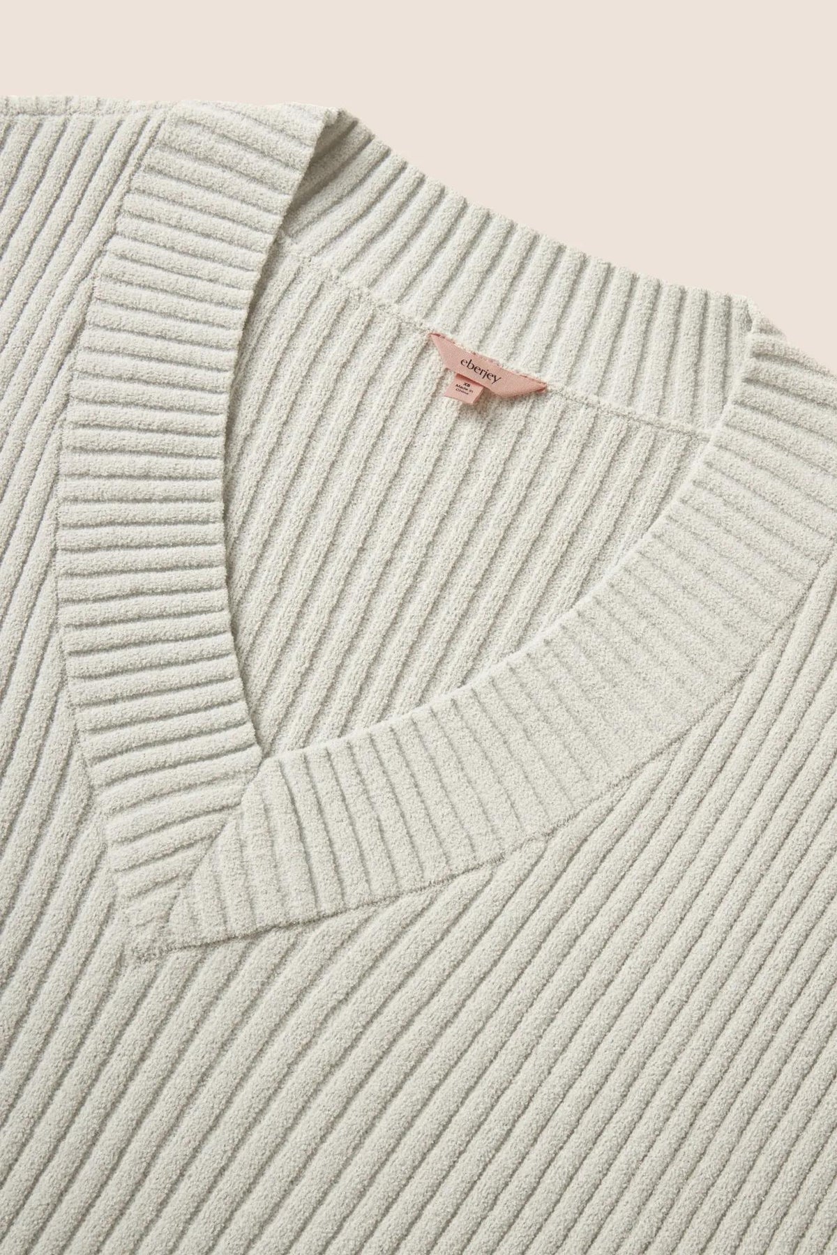Model is wearing Lightweight Boucle Ribbed V Neck Sweater in Blue Mist