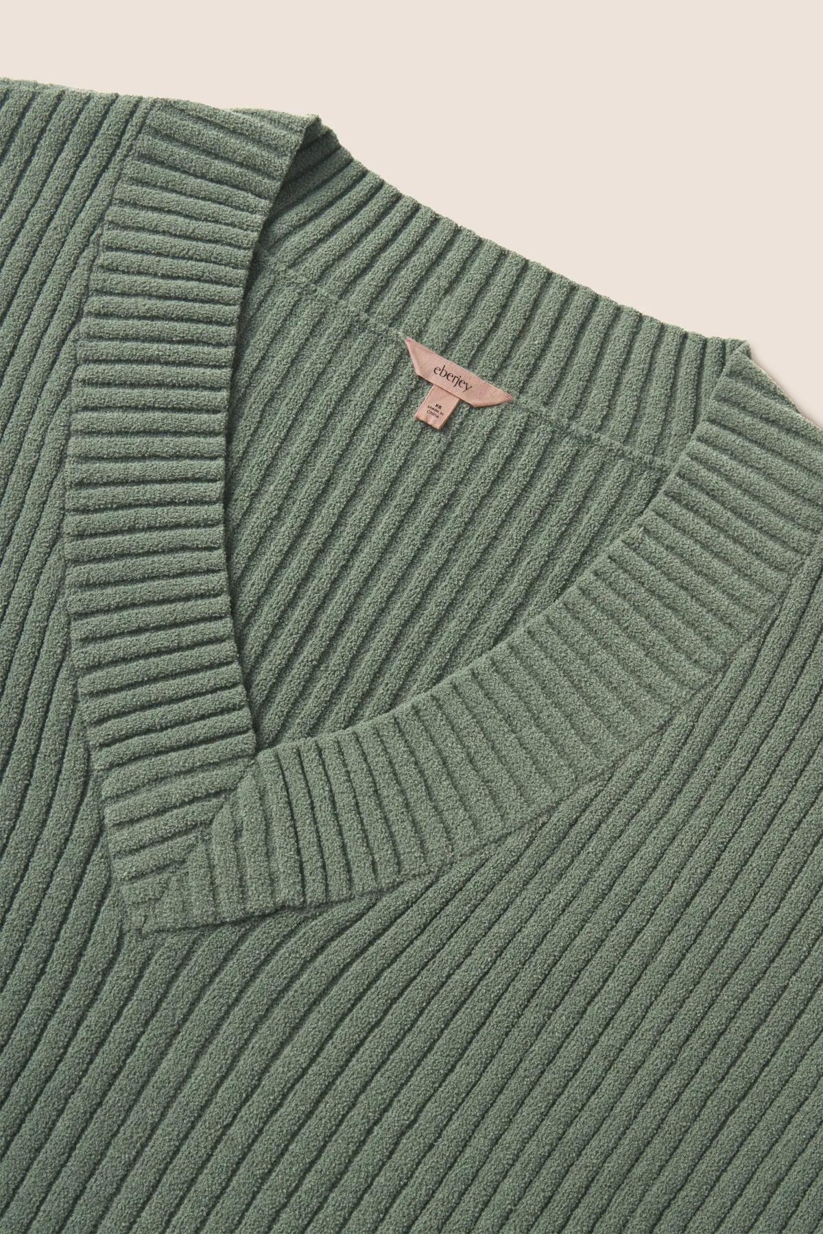 Model is wearing Lightweight Boucle Ribbed V Neck Sweater in Desert Sage