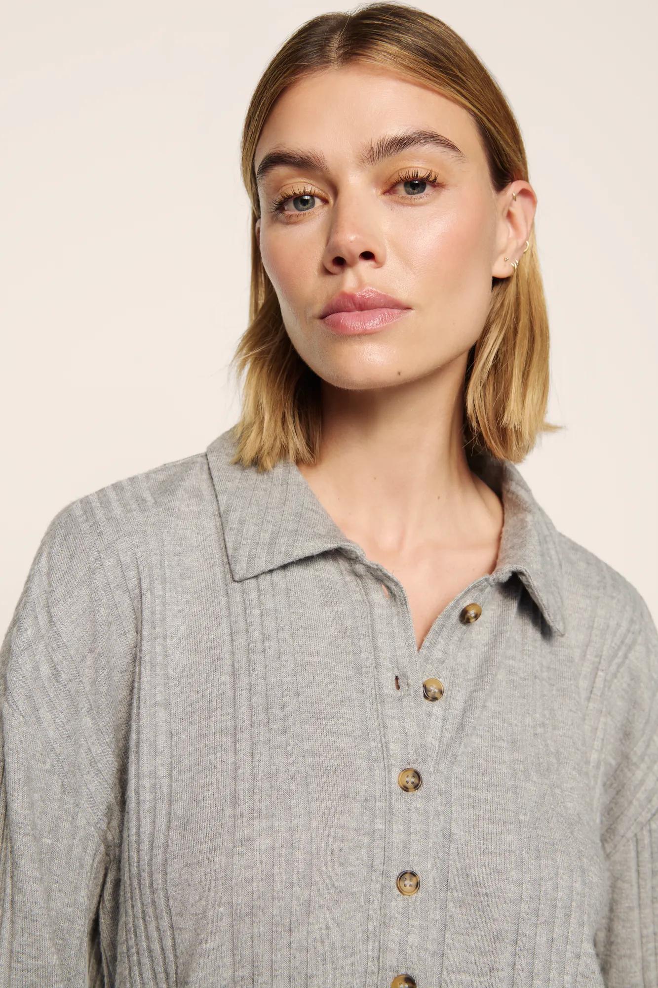 Model is wearing Variegated Rib Long Sleeve Polo in Dark Heather Grey