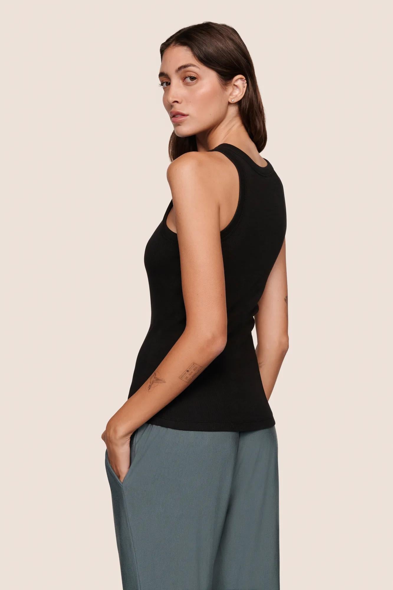 Model is wearing Essential Rib Tank  in Black