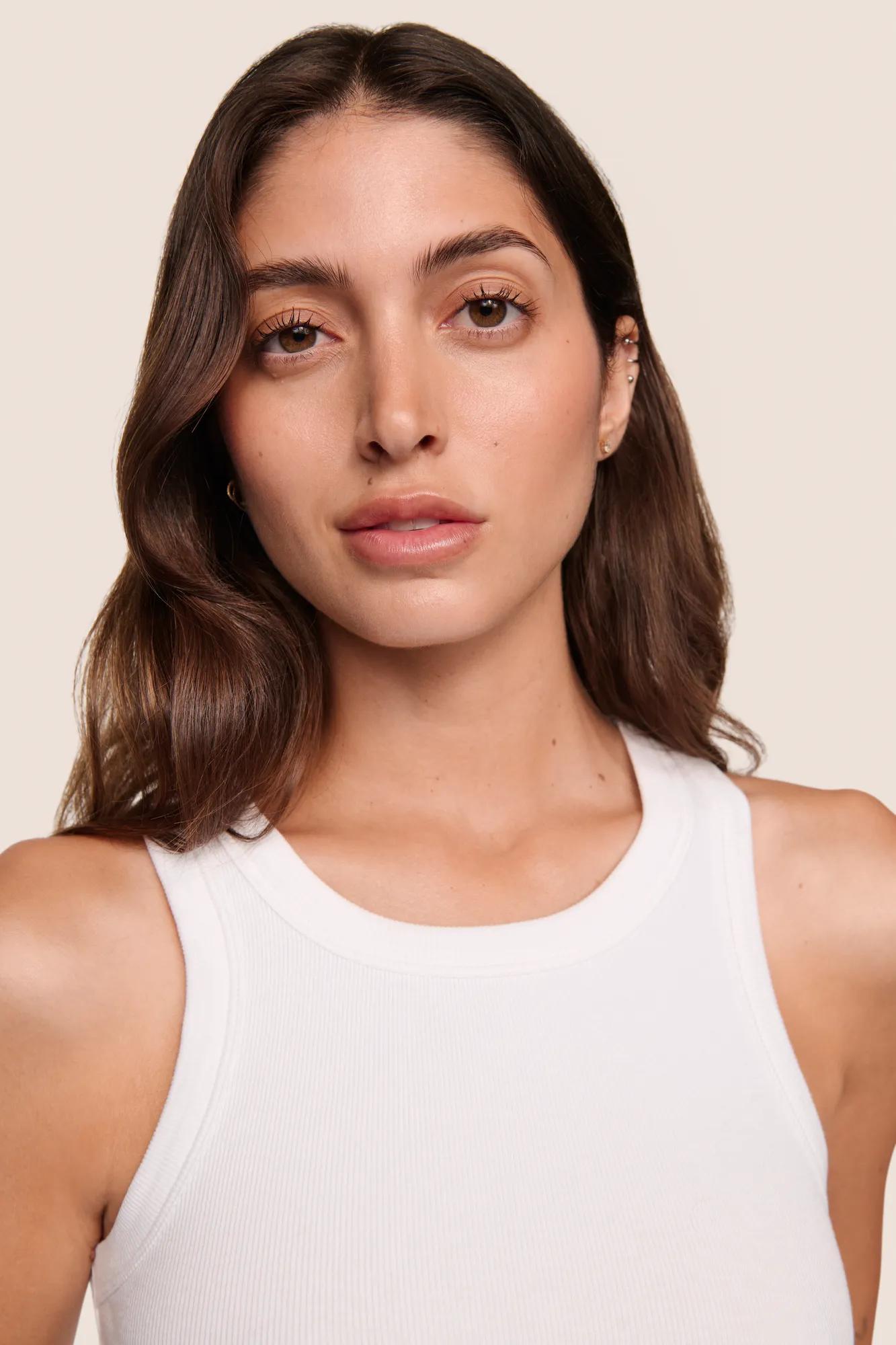 Model is wearing Essential Rib Tank  in White