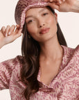 Model is wearing Inez Washable Silk Printed Eye Mask in Bloomscape Misty Rose/Mesa Rose