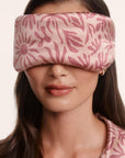 Model is wearing Inez Washable Silk Printed Eye Mask in Bloomscape Misty Rose/Mesa Rose