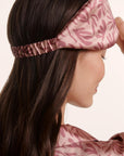 Model is wearing Inez Washable Silk Printed Eye Mask in Bloomscape Misty Rose/Mesa Rose