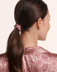 Model is wearing EBJ X ILIA SCRUNCHIE 2PK in Brushstroke Rose/Bloomscape