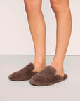 Model is wearing Plush Mule Slipper  in  Deep Taupe