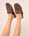 Model is wearing Plush Mule Slipper  in  Deep Taupe
