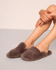 Model is wearing Plush Mule Slipper  in  Deep Taupe