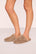 Model is wearing Plush Mule Slipper  in  Toffee