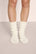 Model is wearing Cozy Socks in Ivory