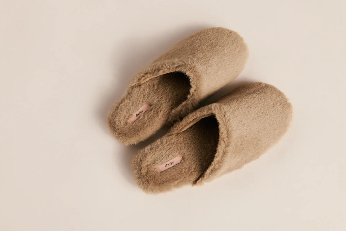 Model is wearing Plush Mule in Toffee