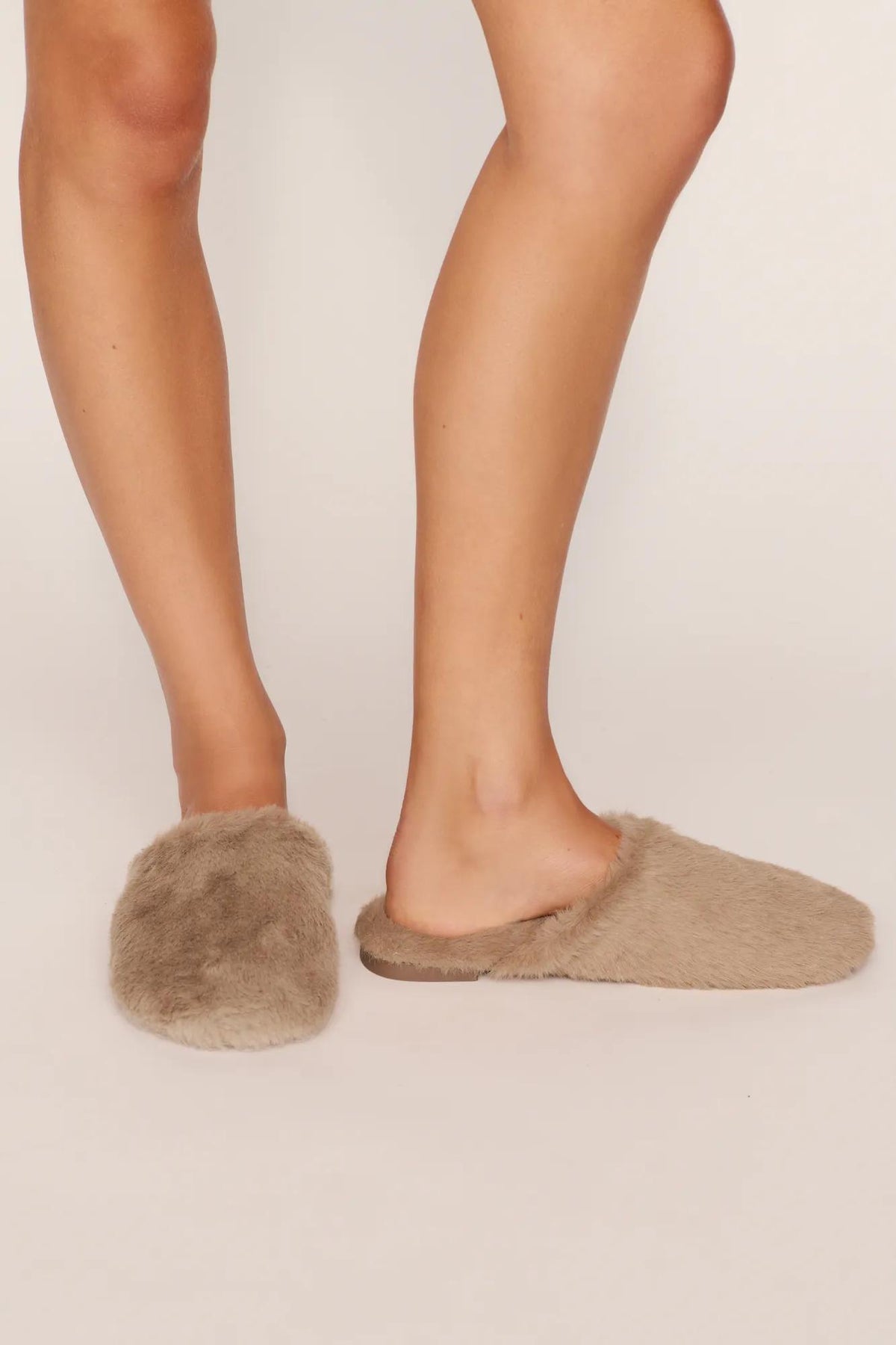 Model is wearing Plush Mule in Toffee