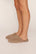 Model is wearing Plush Mule in Toffee