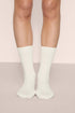 Model is wearing Essential Rib Socks in Ivory