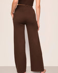Model is wearing Recycled Sweater Pant  in  Chocolate