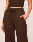 Model is wearing Recycled Sweater Pant  in  Chocolate