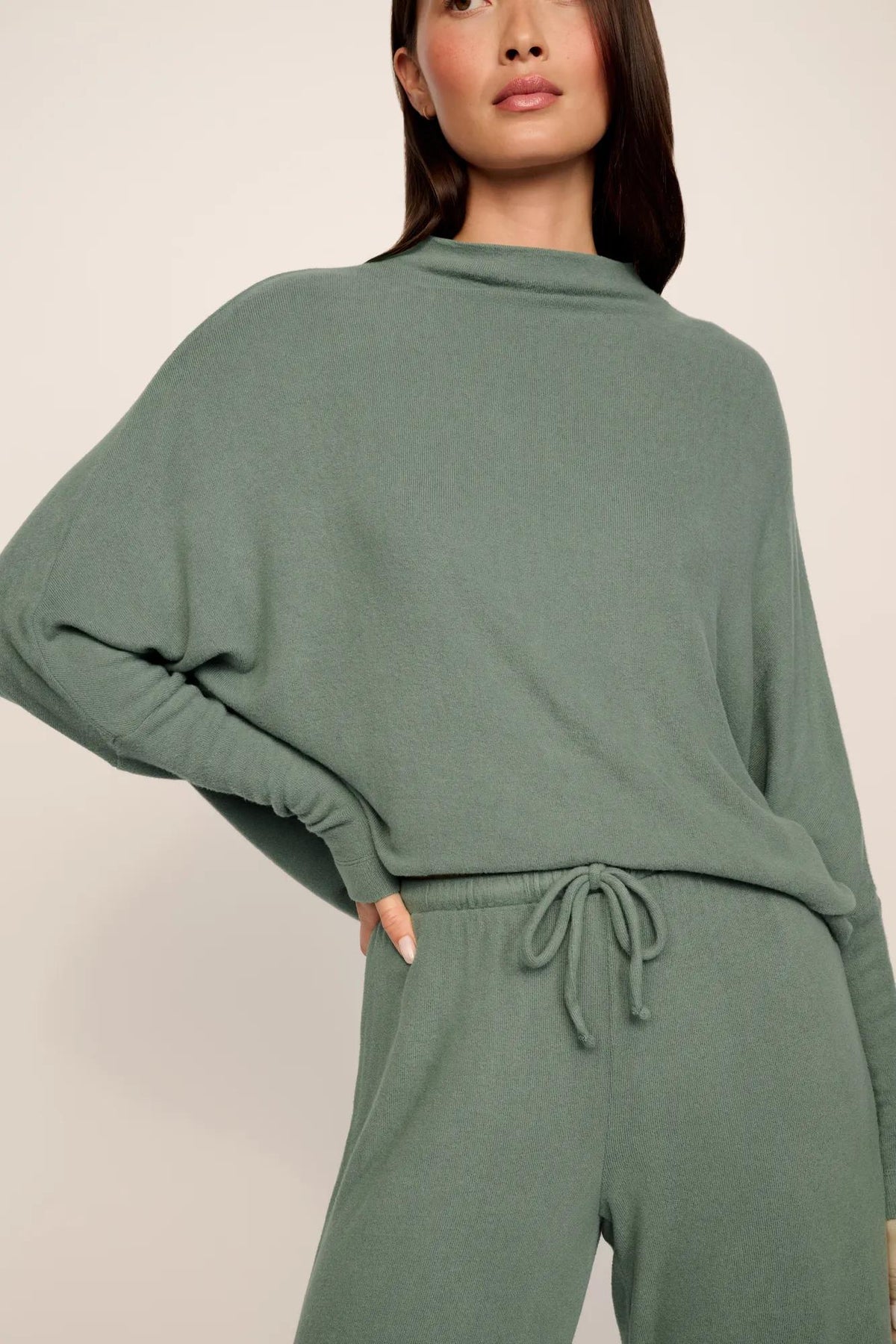 Model is wearing Cozy Time Mock Neck Pullover in Desert Sage