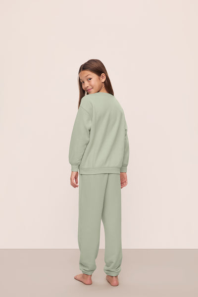 Model is wearing Kid's French Terry Sweatshirt and Jogger Set in  Matcha