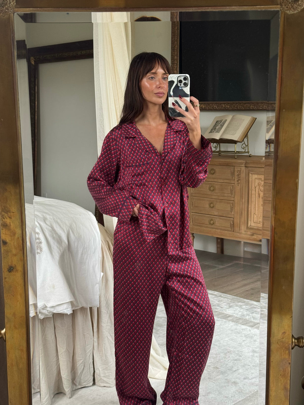 Model is wearing Inez Washable Silk Printed Long PJ Set in Harlequin Holly Red/Navy