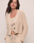 Model wears Recycled Sweater Cropped Cardigan in Oat.