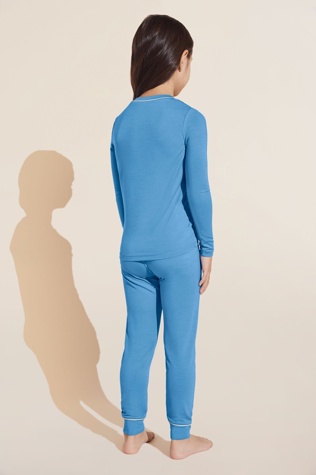 Model wears Kids TENCEL™ Modal Unisex Long PJ Set in Old Azure/Ivory.