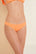 Model wears Annia Textured Bikini Bottom in Cantaloupe. 