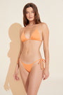 Model wears Nessa Textured Bikini Top in cantaloup. 