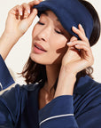 Model wears Inez Washable Silk Eye Mask in navy.